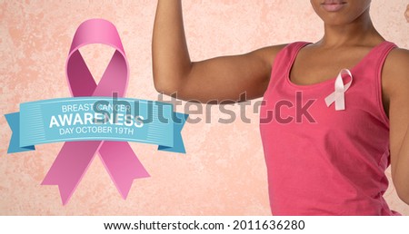 Composition of pink ribbon anchor logo and breast cancer text, with woman raising fist. breast cancer positive awareness campaign concept digitally generated image.