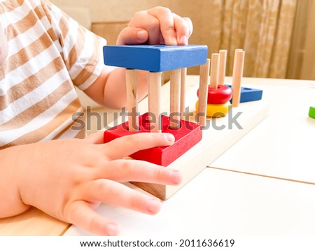 Toy made of wood for the study of shapes and colors. Useful game for a child on a white table. Montessori Education. Materials for the school. Materials on geometry. the concept of teaching children.
