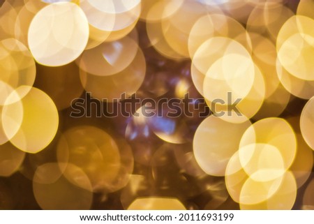 Christmas lights blured background. Light bokeh from Xmas decoration. Abstract holiday backdrop.