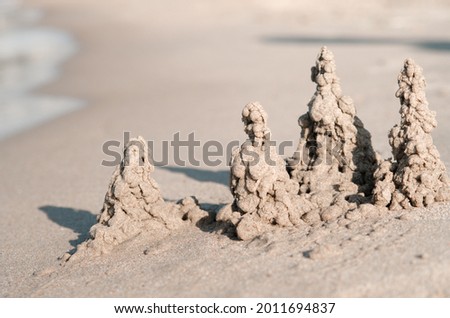 Shot of sand castle on the beach. Summer background