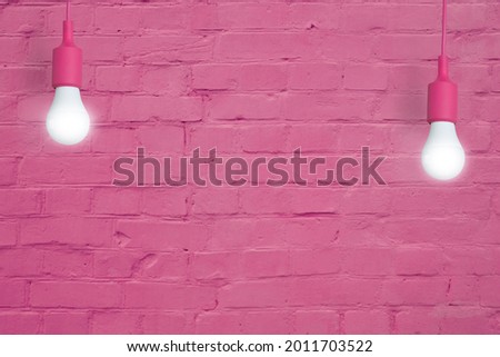 Pink brick wall with light bulbs. Copy space for your text or image