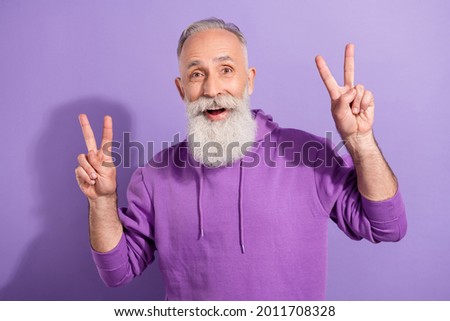Portrait of attractive funky cheerful grey-haired man showing double v-sign isolated over purple violet color background