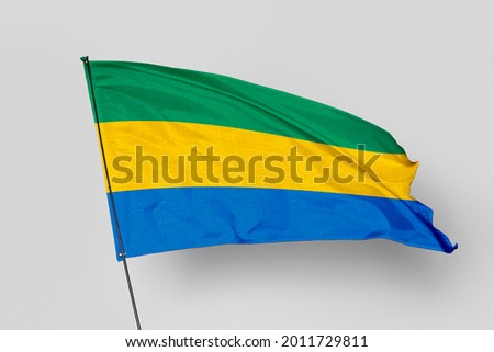 Gabon flag isolated on white background. National symbol of Gabon. Close up waving flag with clipping path.