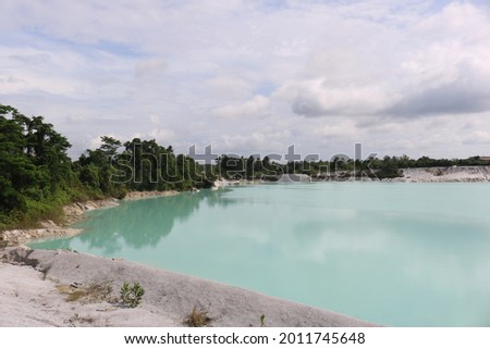 limestone mining on Bangka island have a blue lake and surrounds by white sand and trees