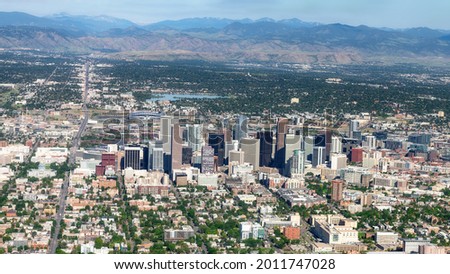 Street leads past the city of Denver Colorado with Mountain backdrop