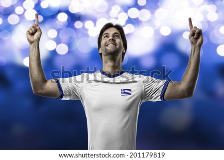 Greek soccer player, celebrating on a blue lights background.