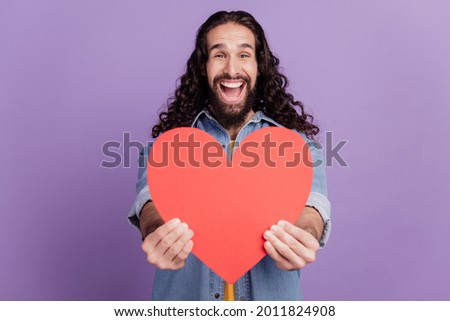 Closeup of happy smiling guy hold heart figure excited face