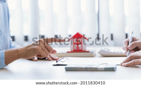 Real estate agent meeting customer with insurance policy about house contract.
