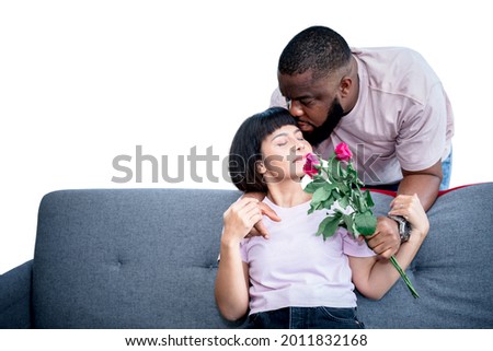 Portrait images couple, African American husband gives roses flower and kissing his wife with love, On white isolated background, to people African black skin and Valentine's day concept.