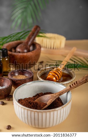 Ingredients for making homemade coffee skincare scrub on a table. Eco friendly cosmetics, vertical photo