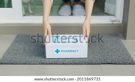 Close-up hand young asia woman pick up covid free first aid self recover health care give to help patient people buy online clinic retail Rx drugstore in telehealth telemedicine e-commerce home order. Royalty-Free Stock Photo #2011869731
