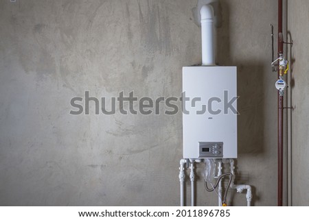 Double-circuit gas boiler in a new house for winter heating and water heating. Royalty-Free Stock Photo #2011896785