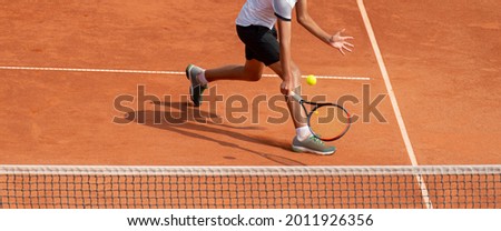 Male tennis player in action on the court on a sunny day. Professional sport concept. Horizontal sport poster, greeting cards, headers, website Royalty-Free Stock Photo #2011926356