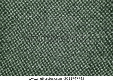 Military dark green fabric alternated with lighter tones. Fabric surface in green tones.