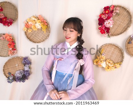 An Asian female model wearing hanbok, the beautiful traditional clothing of Korea. Hanbok has many charms and is elegant and luxurious clothing. Royalty-Free Stock Photo #2011963469