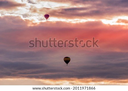 Hot Air Balloons traveling to a destination unknown, seen in St-Jean-Sur-Richelieu, Québec, Canada. Royalty-Free Stock Photo #2011971866