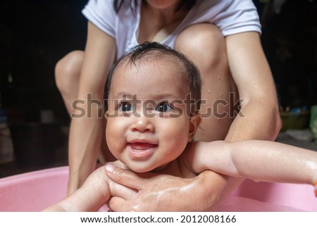 mother taking baby a bath,Baby happy having a bath