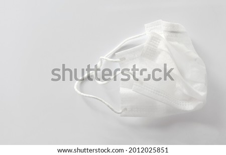 Used medical face mask was thrown away on white background. Health care concepts.  Royalty-Free Stock Photo #2012025851