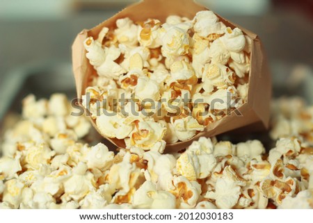 Close-up picture white popcorn in bag peper made of corn is a delicious food or snack to eat in the cinema use it as a background image.
