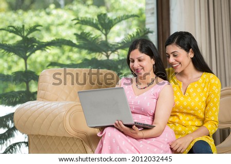 Mother and daughter doing online shopping at home Royalty-Free Stock Photo #2012032445