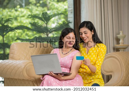 Mother and daughter doing online shopping at home Royalty-Free Stock Photo #2012032451