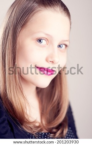 Happy teen girl with painted lips posing and smiling