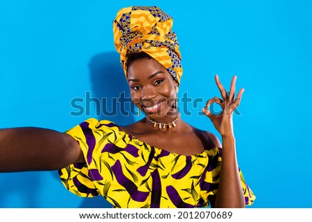 Photo of young stunning cheerful african woman take selfie showing okay sign isolated on blue color background