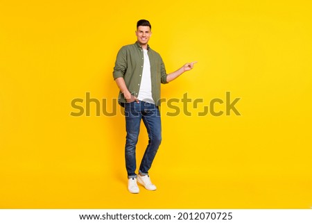 Full length body size photo guy pointing copyspace isolated vibrant yellow color background