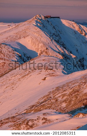 Mountain range in the Low Tatras with north-east slopes of the peak Chopok on a foreground at sunrise,winter morning Slovakia.