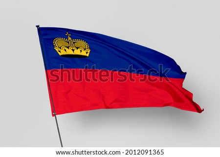 Liechtenstein flag isolated on white background. National symbol of Liechtenstein. Close up waving flag with clipping path.