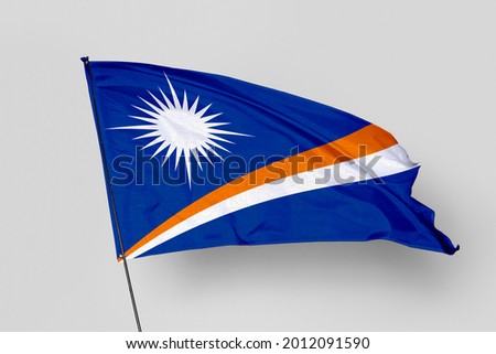 Marshall Islands flag isolated on white background. National symbol of Marshall Islands. Close up waving flag with clipping path.