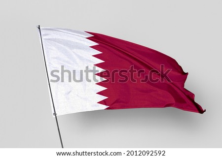 Qatar flag isolated on white background. National symbol of Qatar. Close up waving flag with clipping path.