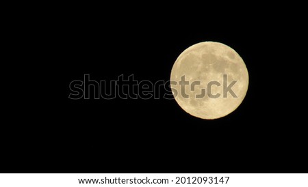 big moon in the night sky. Super full moon with dark background. Horizontal Photography.
