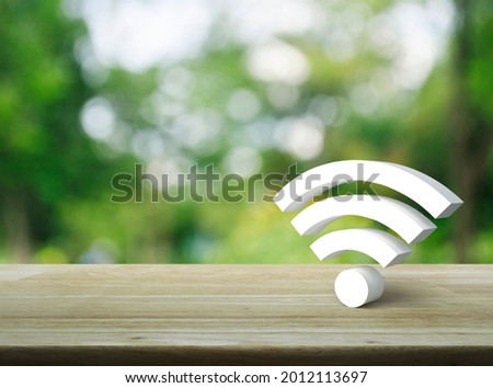 Wi-fi 3d icon on wooden table over blur green tree in park, Technology internet communication concept Royalty-Free Stock Photo #2012113697