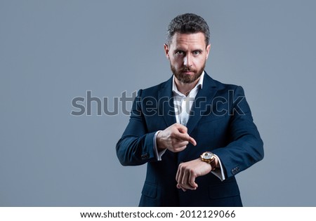 businessman pointing finger on hand watch checking time, copy space, deadline Royalty-Free Stock Photo #2012129066