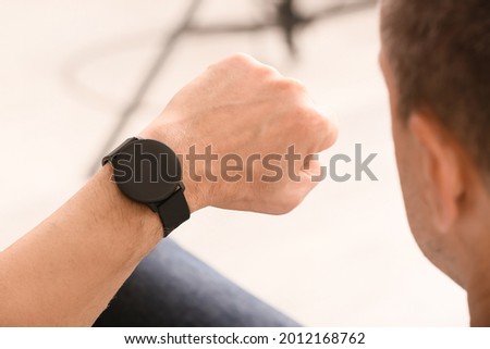 Man looking at his smart watch, closeup