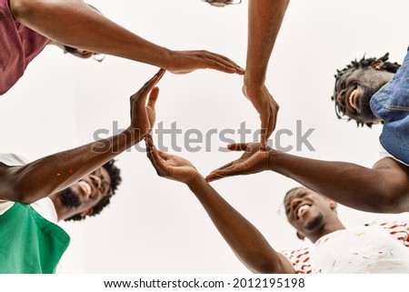 Group of young african american artist man smiling happy doing circle with hands together at art studio.