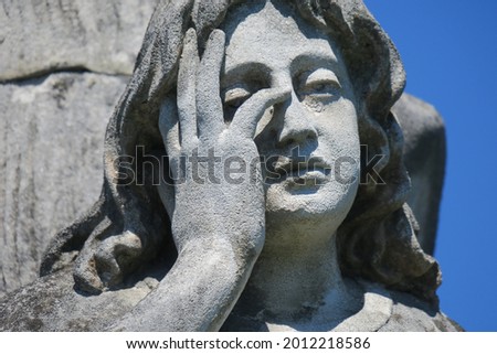 Stone sculpture on the grave in a Christian cemetery