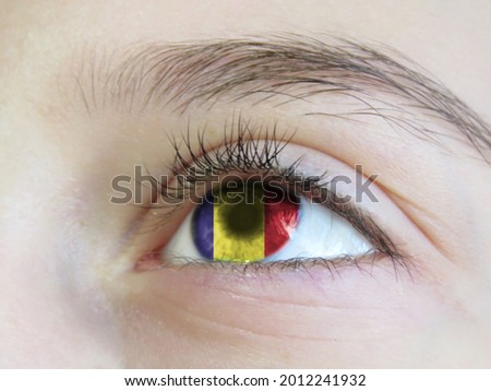 Portrait of a young girl with the color of the eyes of the flag of Romania