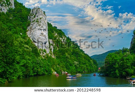 Sculpture in the mountain rock. The tallest in Europe. It represents the face of the Dacian king Decebalus. Royalty-Free Stock Photo #2012248598