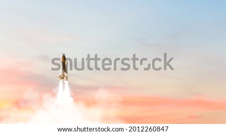 Business Startup Concept : Launch of Space Shuttle Atlantis, Rocket or spaceship take off and flying to sky. (Elements of this image furnished by NASA.) Royalty-Free Stock Photo #2012260847