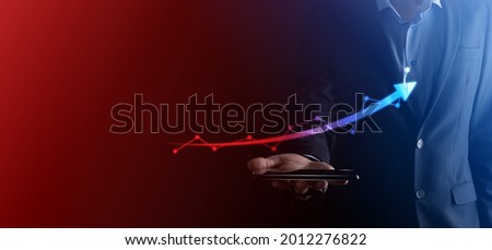 Businessman hold drawing on screen growing graph, arrow of positive growth icon.pointing at creative business chart with upward arrows.Financial, business growth concept.
