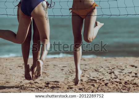 candid Friends playing annd jumping beach volleyball cinematic picture style 