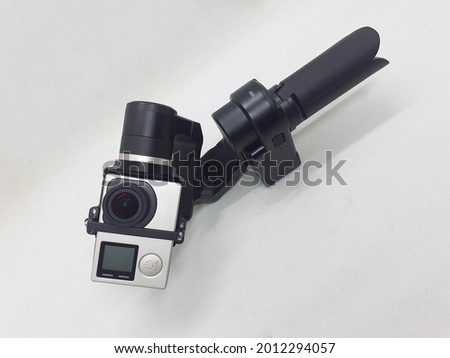 Modern Electronic Mobile Simple Small Portable Gimbal for Sport Action Camera Videography in White Isolated Background