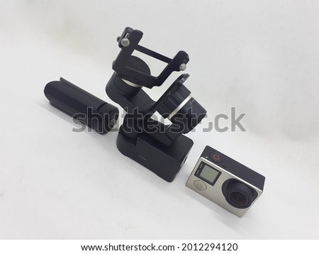 Modern Electronic Mobile Simple Small Portable Gimbal for Sport Action Camera Videography in White Isolated Background