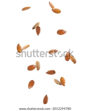 Many linseeds falling on white background. Vegan diet   Royalty-Free Stock Photo #2012294780