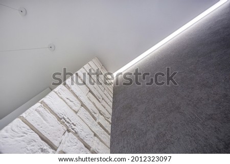 suspended ceiling with halogen spots lamps and drywall construction in empty room in apartment or house. Stretch ceiling white and complex shape. Royalty-Free Stock Photo #2012323097