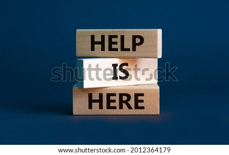 Help is here and support symbol. Wooden blocks with words 'Help is here' on beautiful grey background. Business, support, help is here concept. Copy space.
