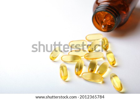 Omega 3 capsules on a white background with place for text.