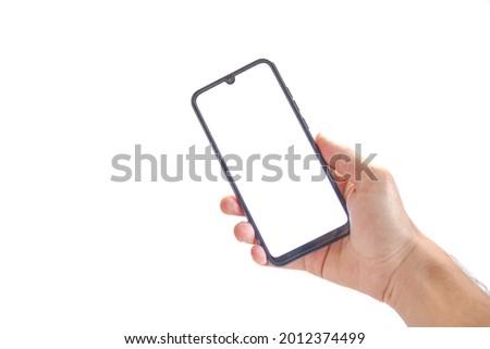 The hand holding black smartphone, blank white screen phone isolated on white background, mockup image, clipping path, copy space.